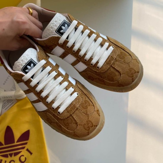 Gucci Gazelle Yellow Canvas Trainers Top View in yellow and white Top front view of a pair of yellow canvas Gucci Gazelle trainers displaying white laces and patterned upper