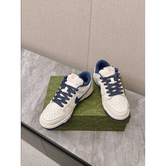 Gucci Low Top Leather Trainers In White And Blue Front View Front overhead view of Gucci Low Top Leather Trainers In White And Blue resting on green box