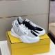 Pair of Fendi Flow Bicolor Trainers on Box in white and grey Pair of black and white Fendi Flow trainers resting on a yellow shoe box in white and grey