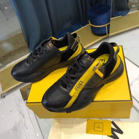Fendi Flow Black Leather Trainers Angled Pair in black and yellow Angled pair of Fendi Flow black leather and yellow accent low top trainers on top of a yellow brand box