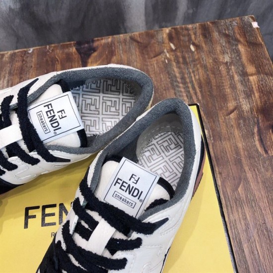 Close-up view of tongue logo label and padded collar lining on Fendi low-top trainers in black and off-white