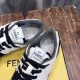 Close-up view of tongue logo label and padded collar lining on Fendi low-top trainers in black and off-white