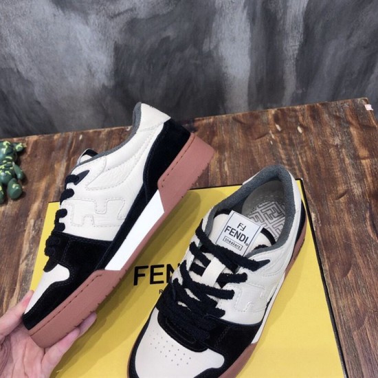 Angled view of Fendi Match low-top trainers showing side panels and brown sole in black and off-white