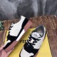 Angled view of Fendi Match low-top trainers showing side panels and brown sole in black and off-white