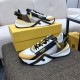 Pair of Fendi Flow multicolour trainers arranged on a surface next to a yellow shoe box in multicolour and white