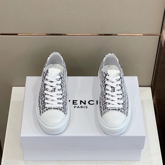 Top-down view of both black and white Givenchy City 4G jacquard trainers on a shoe box