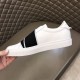 Givenchy White Leather Trainer Medial Side View in white and black Hand holding Givenchy white trainer showing medial side without logo patch in white and black