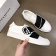 Givenchy White Leather Trainer Side Profile in Hand in white and black Hand holding a Givenchy white leather trainer showing side sole and rubber logo patch in white and black