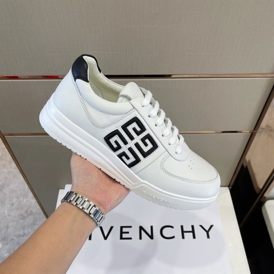 Givenchy G4 Leather Trainer Side View in white and black Hand holding side view showing 4G logo on Givenchy G4 Leather Trainer in white and black