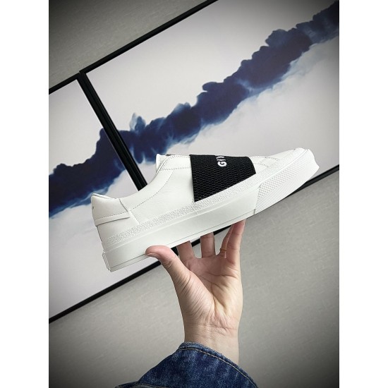 Givenchy White Trainer Side Profile View in white and black Hand holding side profile of Givenchy white leather trainer with textured midsole in white and black
