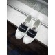 Givenchy Elastic Band Trainers Top View in white and black Pair of Givenchy white trainers with black logo elastic bands on a window ledge