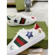Close-up view of side panels and metallic star embroidery on Gucci Ace Embroidered white leather trainers in white and green