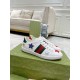 Pair of Gucci Ace Embroidered Leather Low Top Trainers in white resting on a branded green box.
