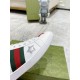 Detailed view of white leather eyelets, green and red web stripe, and metallic silver star on Gucci Ace Trainers.
