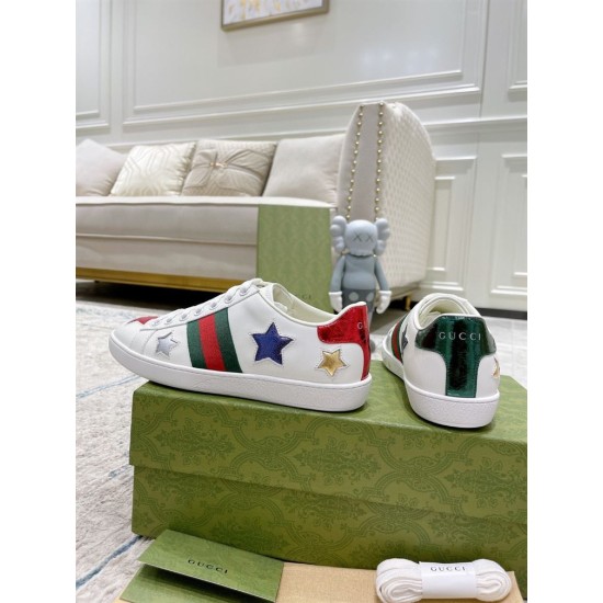 Rear angle view of white Gucci Ace Embroidered Trainers displaying metallic red and green heel tabs with brand logo.