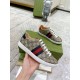 Gucci Ace GG Supreme Canvas Web Stripe Trainers Handheld View in beige and brown Hand holding Gucci Ace GG Supreme Canvas Web Stripe Trainers in beige and brown monogram canvas