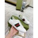 Hand holding white Gucci Ace Leather Trainers With Web Stripe showing side stripe