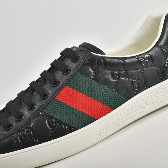 Gucci Ace Embossed Leather Low Top Trainers Black Detail View Close-up of debossed leather and green and red web stripe on Gucci Ace Trainers Black
