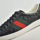 Gucci Ace Embossed Leather Low Top Trainers Black Detail View Close-up of debossed leather and green and red web stripe on Gucci Ace Trainers Black