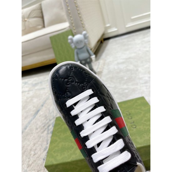 Gucci Ace Black Trainers Lacing Detail in black and red Close-up detail of white laces and embossed black leather toe cap on Gucci Ace trainers in black and red