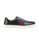 Gucci Ace Black Leather Low Top Trainers in black and red Studio profile shot of black embossed Gucci Ace low top trainers with white laces in black and red