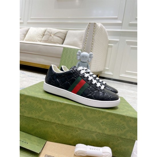 Gucci Ace Black Trainers on Packaging Box in black and red Gucci Ace black low top trainers displayed on a green branded box in black and red