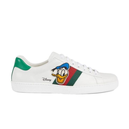 Profile view of white Gucci Ace x Disney Donald Duck leather trainer featuring web stripes