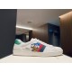 Side view of white leather Gucci Ace trainer with Donald Duck patch on display box