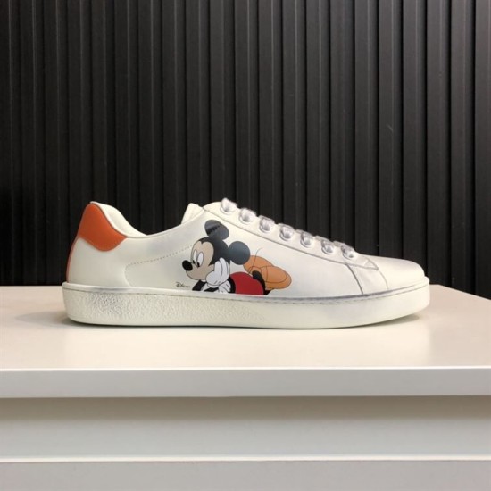 Gucci Ace Disney Mickey Mouse Ivory Trainer Side View in ivory and orange Lateral view of Gucci Ace Disney Mickey Mouse ivory trainer showing smooth leather and low-top design in ivory and orange