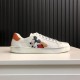 Gucci Ace Disney Mickey Mouse Ivory Trainer Side View in ivory and orange Lateral view of Gucci Ace Disney Mickey Mouse ivory trainer showing smooth leather and low-top design in ivory and orange