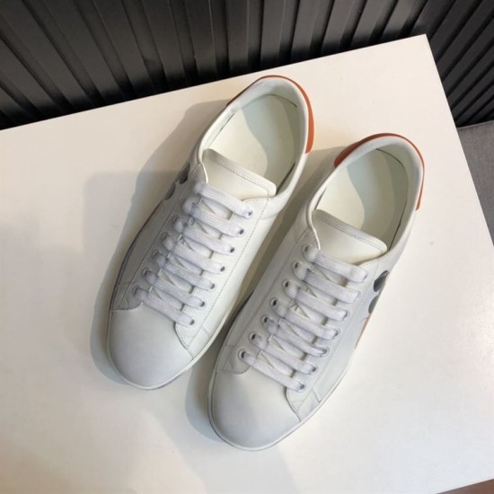 Gucci Ace Disney Mickey Mouse Ivory Trainers Overhead View in ivory and orange Overhead view of Gucci Ace Disney Mickey Mouse ivory trainers detailing white laces and upper construction in ivory and orange