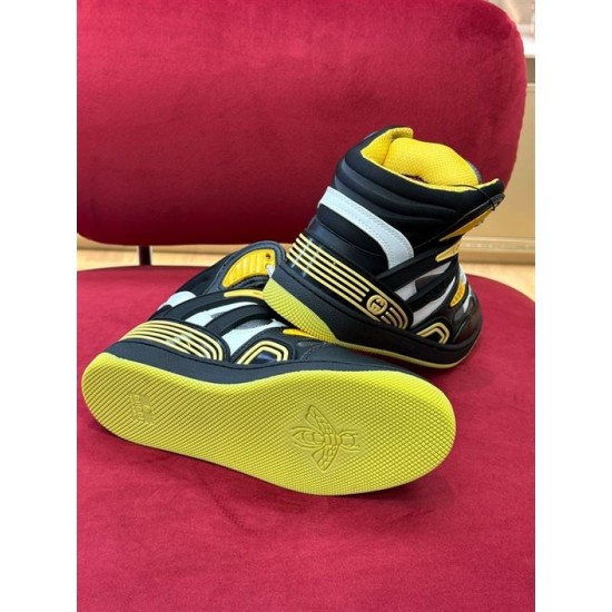 Bottom view showing yellow textured outsole pattern with bee motif on Gucci trainer in black and yellow
