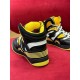 Rear view showcasing ribbed yellow heel support on Gucci Basket trainer in black and yellow