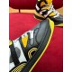 Detailed close-up of side paneling and yellow accents on Gucci high-top trainer in black and yellow