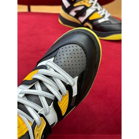 Close-up view of perforated toe box and laces on black and yellow Gucci trainer