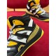Close-up of padded collar and rubber eyelet overlay on Gucci Basket trainer in black and yellow