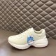 Gucci Rhyton Ivory Trainer Alternate Character in ivory and red Gucci Rhyton ivory trainer on display showing alternate character graphic on lateral side in ivory and red