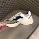 Gucci Rhyton Chunky Trainer Side View in beige and pink Hand holding Gucci Rhyton trainer showing side panelling and chunky sole in beige and pink