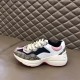 Gucci Rhyton Trainers Outer Profile in beige and pink Outer side view of Gucci Rhyton trainer in beige, navy, and pink on leather seat