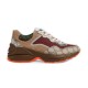 Gucci GG Rhyton Low Top Trainers Side Profile View in beige and brown Side profile view of Gucci GG Rhyton Monogram Canvas Low Top Trainers showing beige brown upper and orange sole