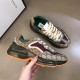 Gucci GG Rhyton Low Top Trainers Handheld Angle in beige and brown Three-quarter side angle of Gucci GG Rhyton Monogram Canvas Low Top Trainers held in hand in beige and brown
