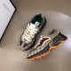 Gucci GG Rhyton Low Top Trainers Angled Pair in beige and brown Pair of Gucci GG Rhyton Monogram Canvas Low Top Trainers arranged at an angle in beige and brown