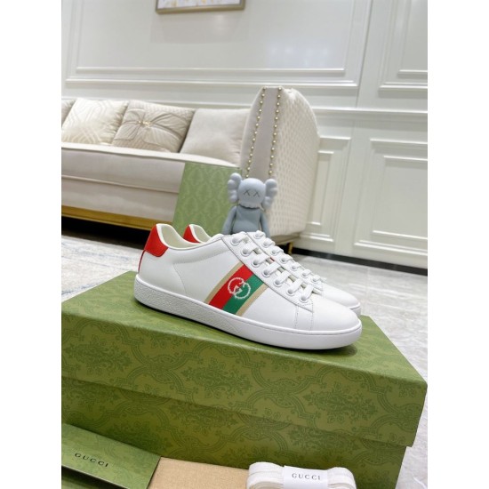 Gucci White Leather Trainers on Shoe Box in white and red Three-quarter view of white leather Gucci trainers resting on green shoe box in white and red