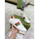 Gucci White Leather Trainer Held in Hand in white and red Hand holding Gucci white leather trainer showing side profile and embroidered logo web stripe