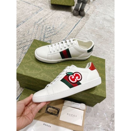 Gucci White Leather Trainers Pair Side View in white and green Side profile of both Gucci white leather trainers showing web stripes and heel tab details in white and green