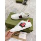 Gucci White Leather Trainers Pair Side View in white and green Side profile of both Gucci white leather trainers showing web stripes and heel tab details in white and green