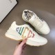 Gucci Rhyton Trainer Handheld Lateral View in ivory Handheld side profile of Gucci Rhyton ivory trainer showing glitter logo