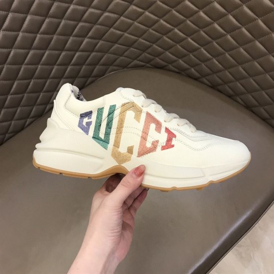 Gucci Rhyton Trainer Lateral Profile in ivory Handheld lateral view of Gucci Rhyton trainer with rainbow glitter print in ivory
