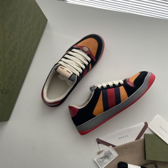 Gucci Screener Trainers In Black Suede And Orange Top View Top-down view of Gucci Screener trainers in black suede and orange displayed on a surface.