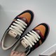 Gucci Screener Trainers In Black Suede And Orange Laces Detail Close-up top view showing cream laces and tongue detailing on black and orange Gucci trainers.
